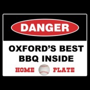 Warning sign reading "Danger. Oxford's best BBQ inside. Home Plate"